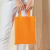 Woman Holding Orange Mini Bag For Life Tote – A4 Size