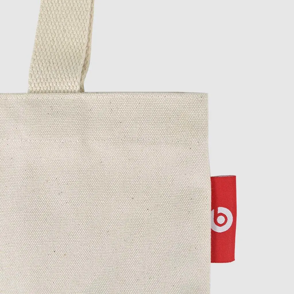 small tote bag in natural fabric with red screen print and woven logolabel