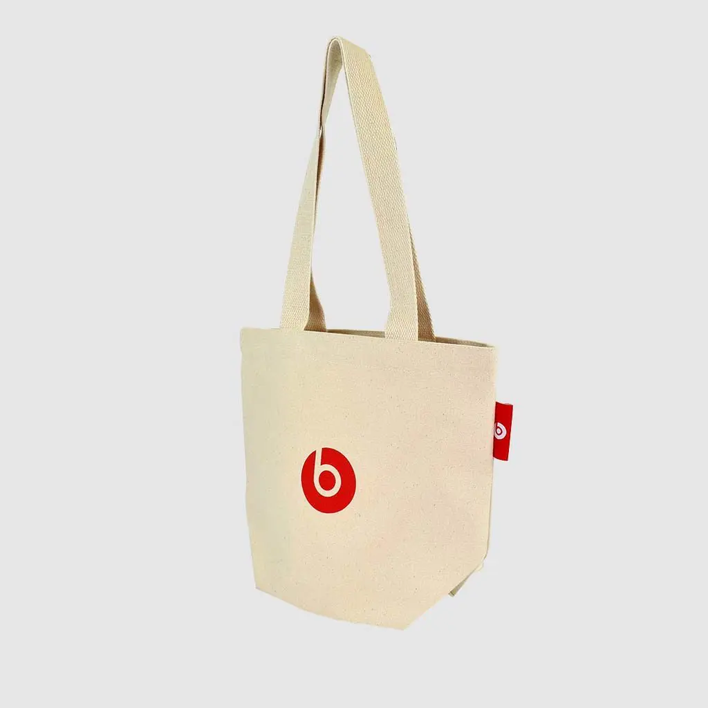 small tote bag in natural fabric with red screen print and label