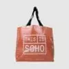 transparent shopping bag in clear tarpaulin with orange felt lining show through