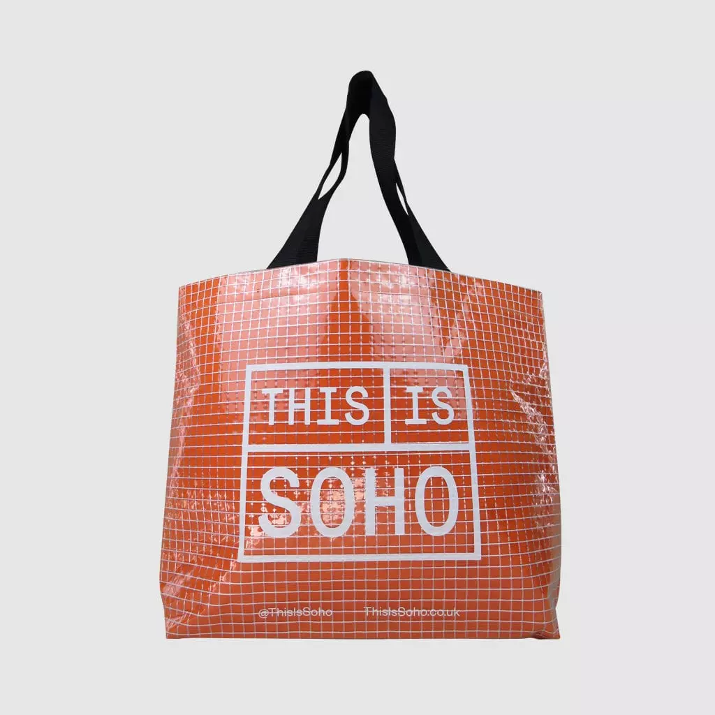 transparent shopping bag in clear tarpaulin with orange felt lining show through