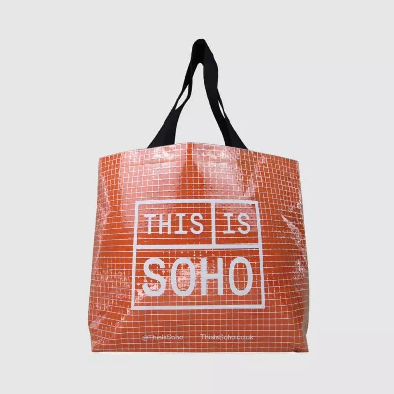 transparent shopping bag in clear tarpaulin with orange felt lining show through