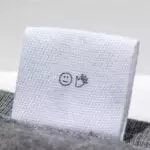 white fabric label for bag with print sewn into grey bag