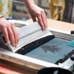 screen print and ink going down on bag for print
