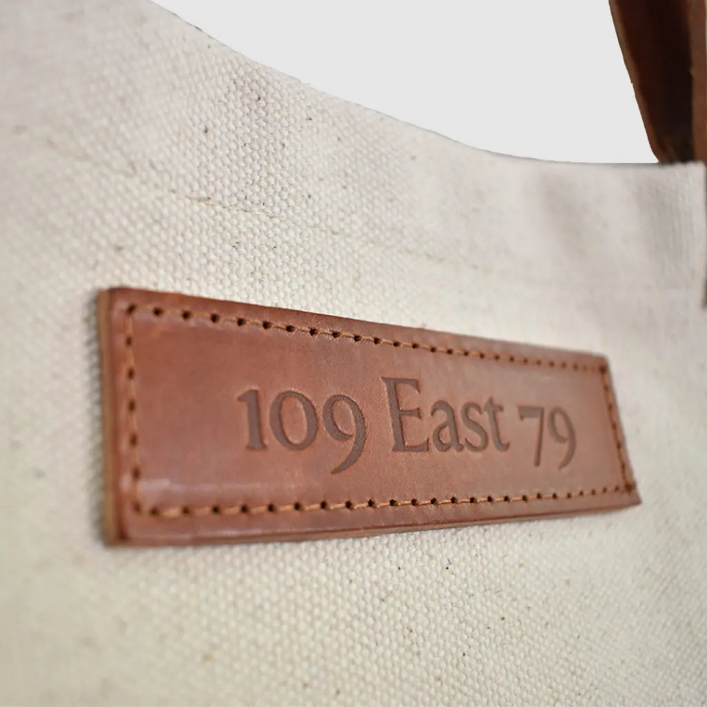 natural canvas tote bag with tan colour PU leather embossed badge
