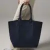 navy boat bag with short handles being carried by person