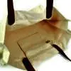 zipped pocket on inside of natural coloured bag with leather handles