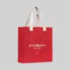 square red jute bag with natural coloured short hand carry handles