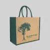 side view of square tote bag with green side panels, handles and print