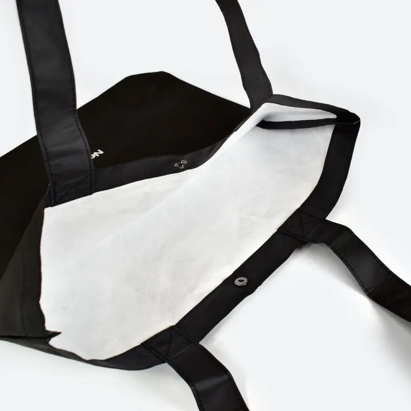 inside view of open tyvek bag that is black on outside and white on inside, taped seams and metal popper closure