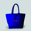 front view of blue luxury landscape tote bag with padded handles and pink print