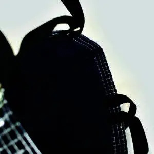 open view of inside of bag showing navy felt lining with black handles on the outside of the top hem