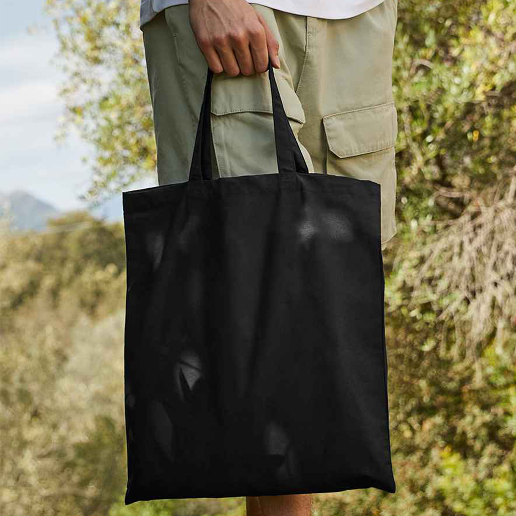 Man Outside Holding 4oz Bag For Life Tote – Short Handles