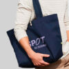 person carrying navy oversized tote bag with purple logo print