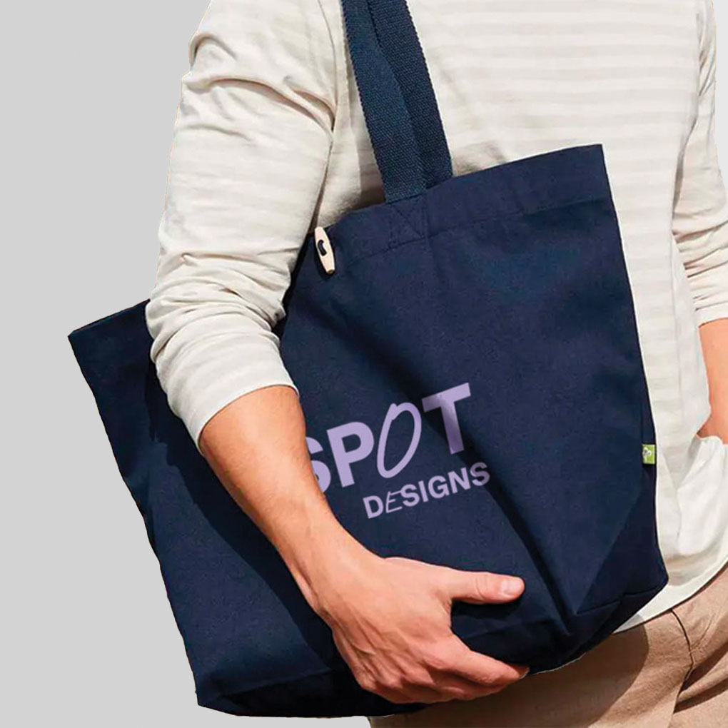 person carrying navy oversized tote bag with purple logo print