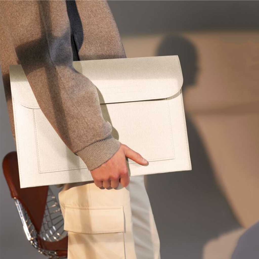 Man Carrying White Felt Laptop Case