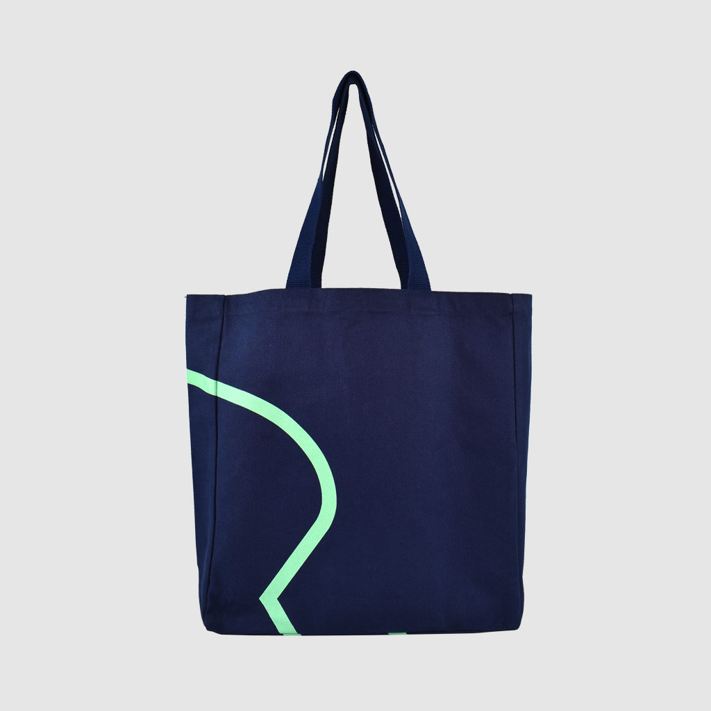 edge to edge print in mint green on large tote bag in navy