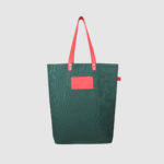 green tote bag with pink PU leather handle and badge