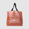 transparent shopping bag in clear tarpaulin with orange felt lining show through