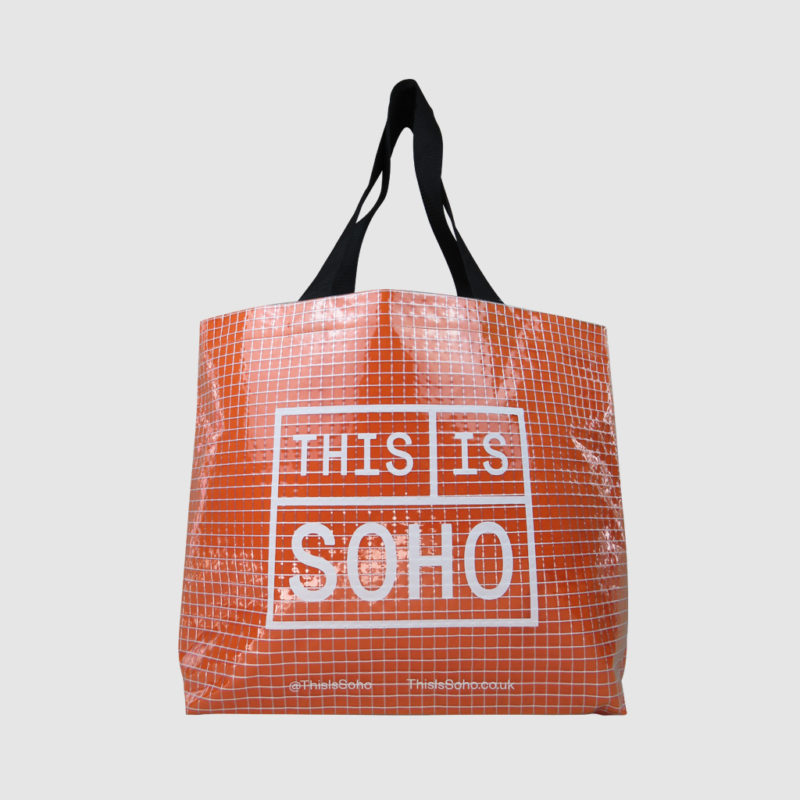 transparent shopping bag in clear tarpaulin with orange felt lining show through