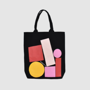 black tote bag with short handle and bright pinks and yellow print