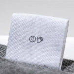 white fabric label for bag with print sewn into grey bag