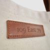 natural canvas tote bag with tan colour PU leather embossed badge