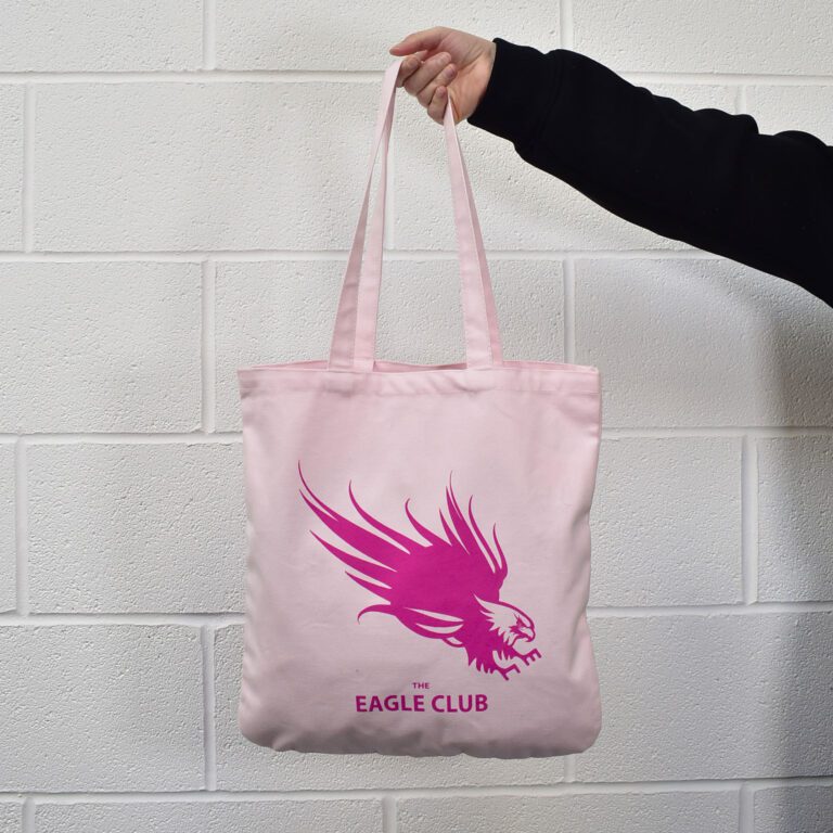 colleague arm holding baby pink coloured tote bag with hot pink print on