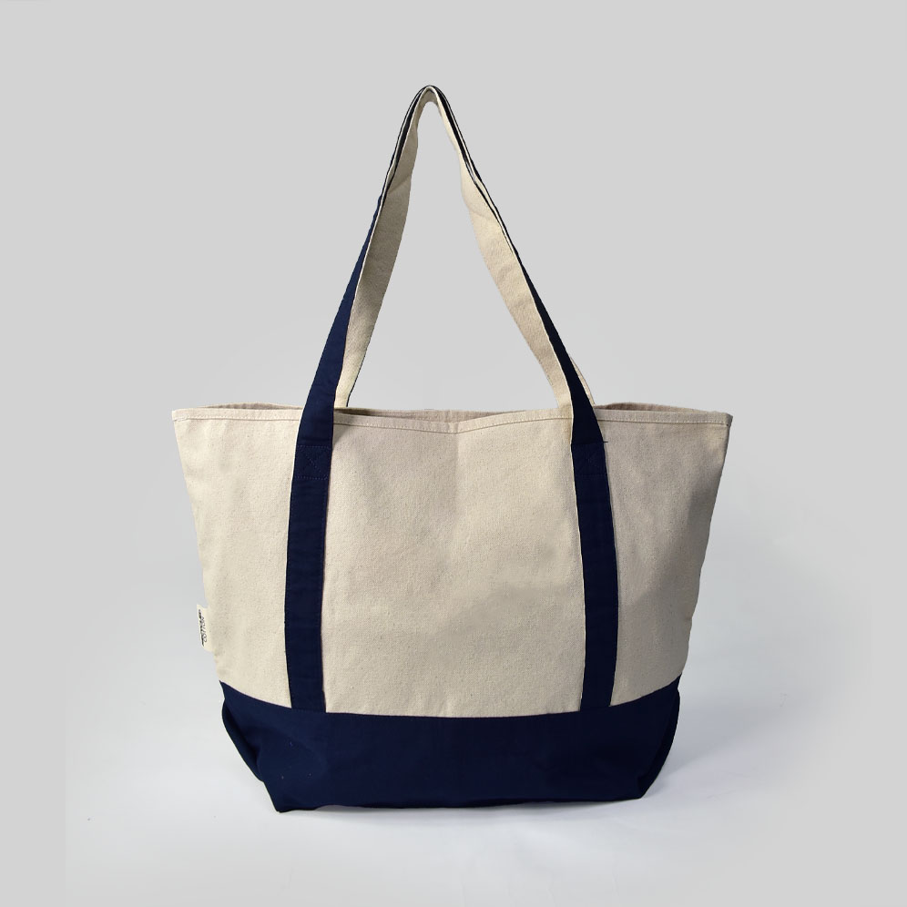 front view of cream bag with black handles and base