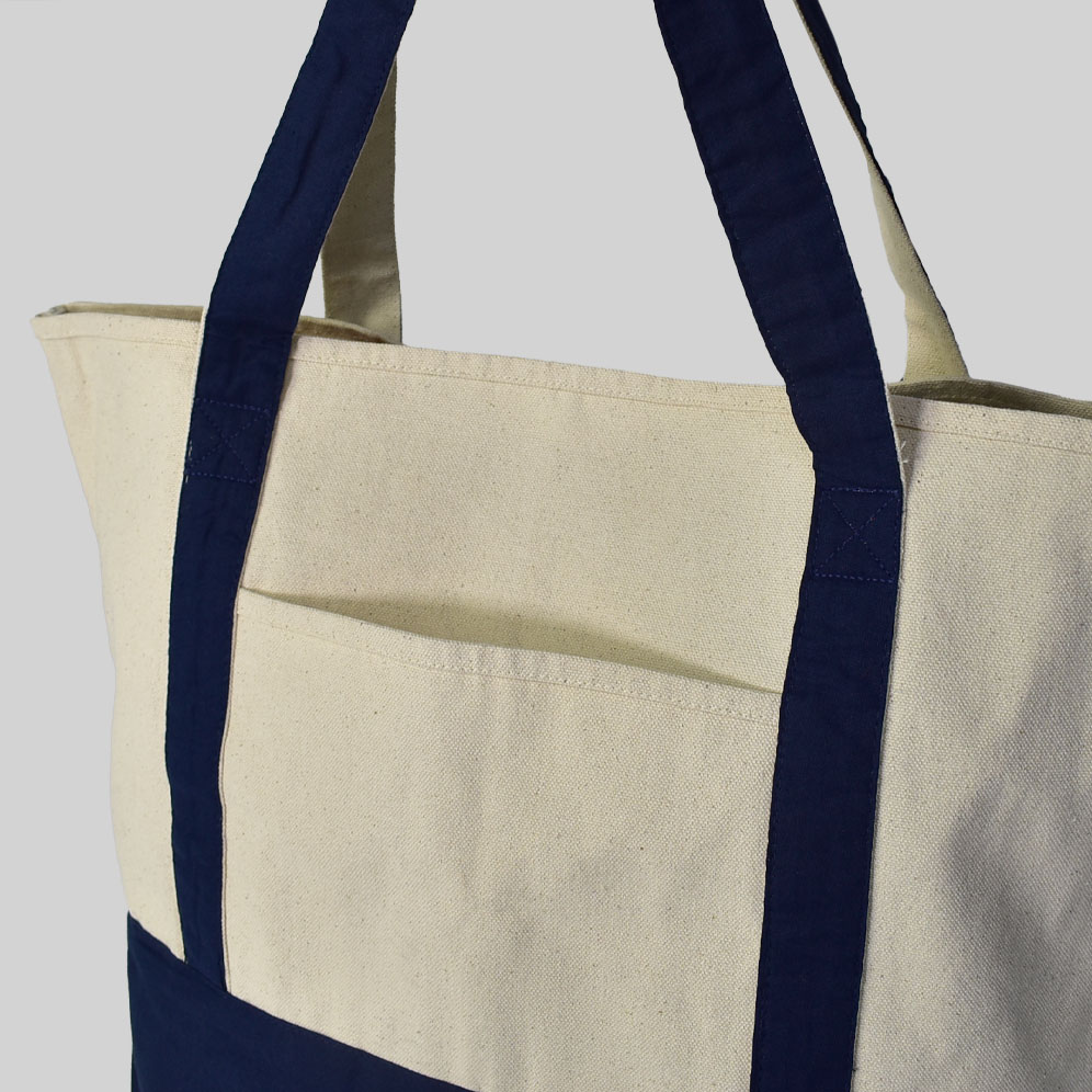 cream bag with navy blue handles and base