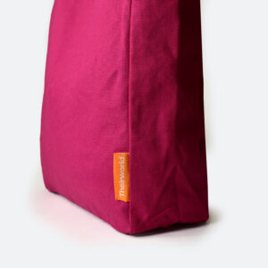 side panel of pink A4 bag with orange woven logo label