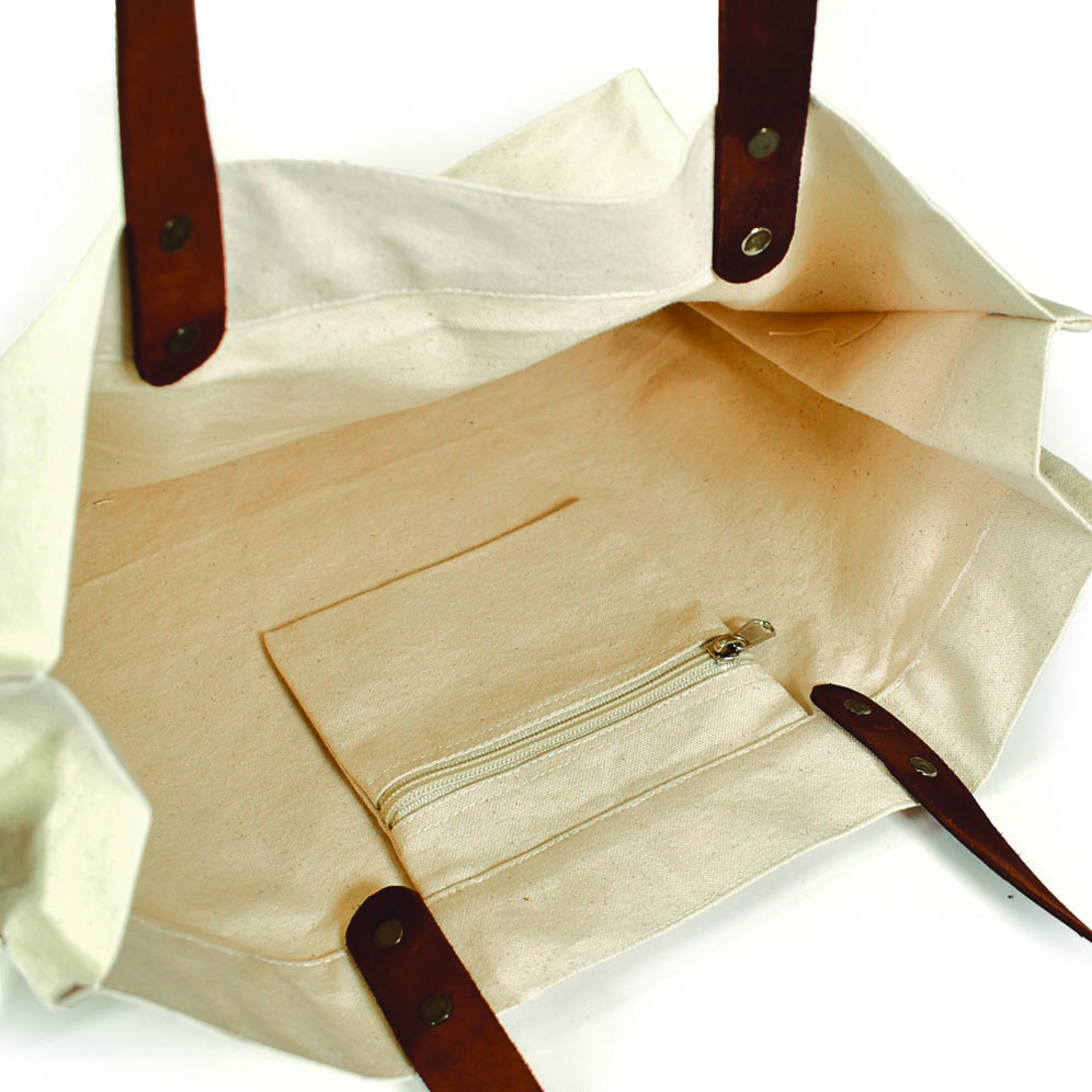 zipped pocket on inside of natural coloured bag with leather handles