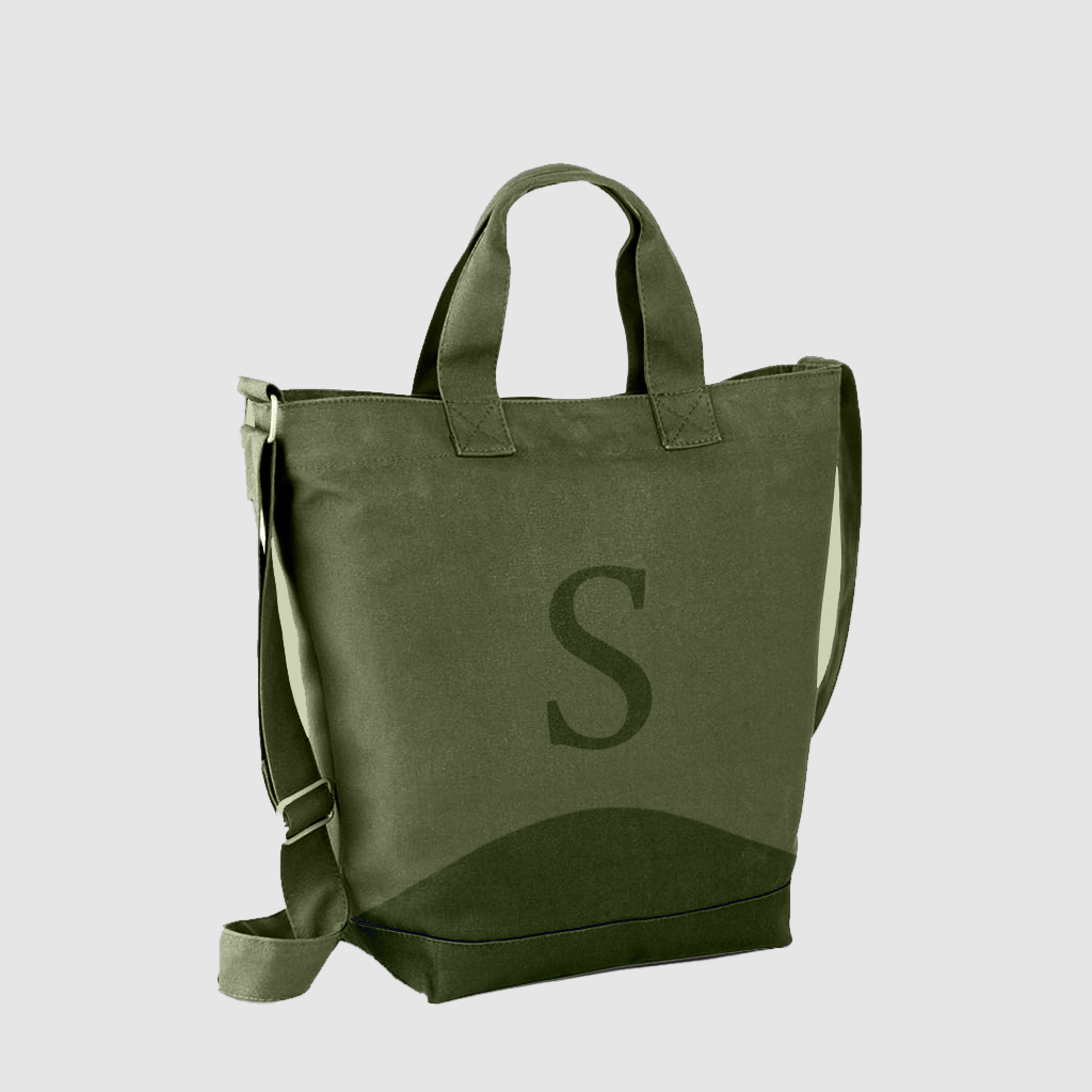 side view of green satchel bag with short handle and long adjustable handle