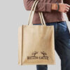 person wearing blue jeans holding brown jute bag with brown print