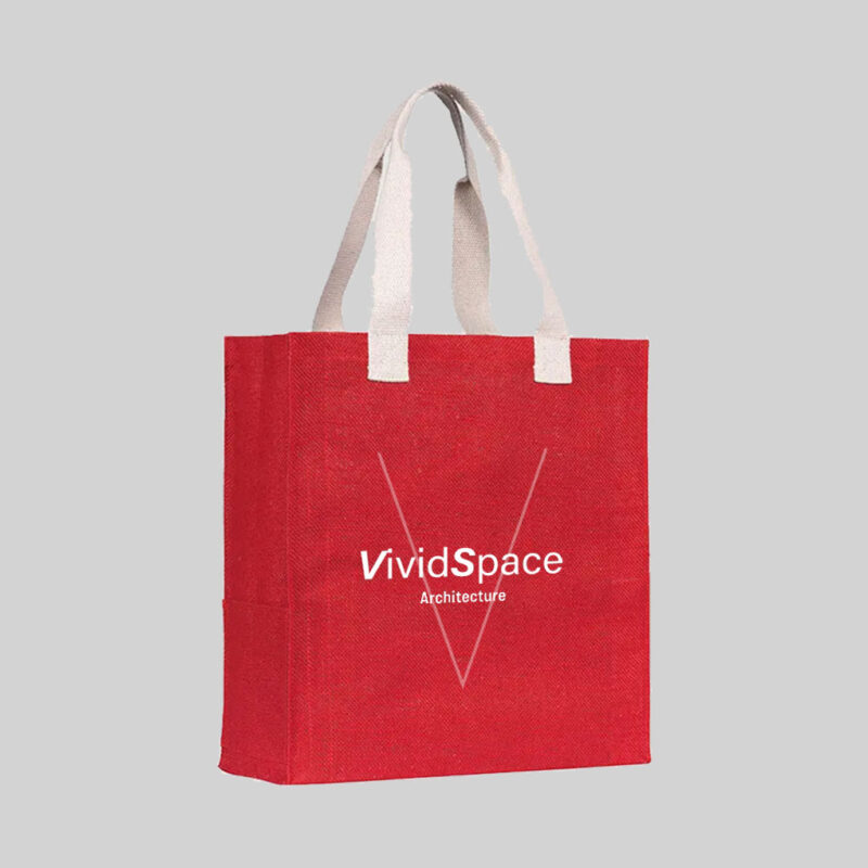 square red jute bag with natural coloured short hand carry handles