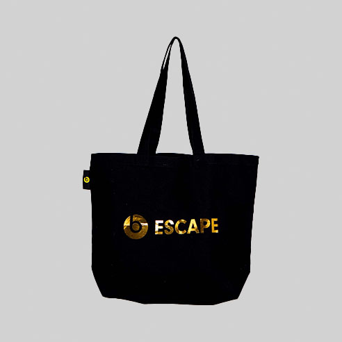 black oversized tote bag with Beats logo on woven label and ESCAPE in gold mirror print how to work with a British vendor