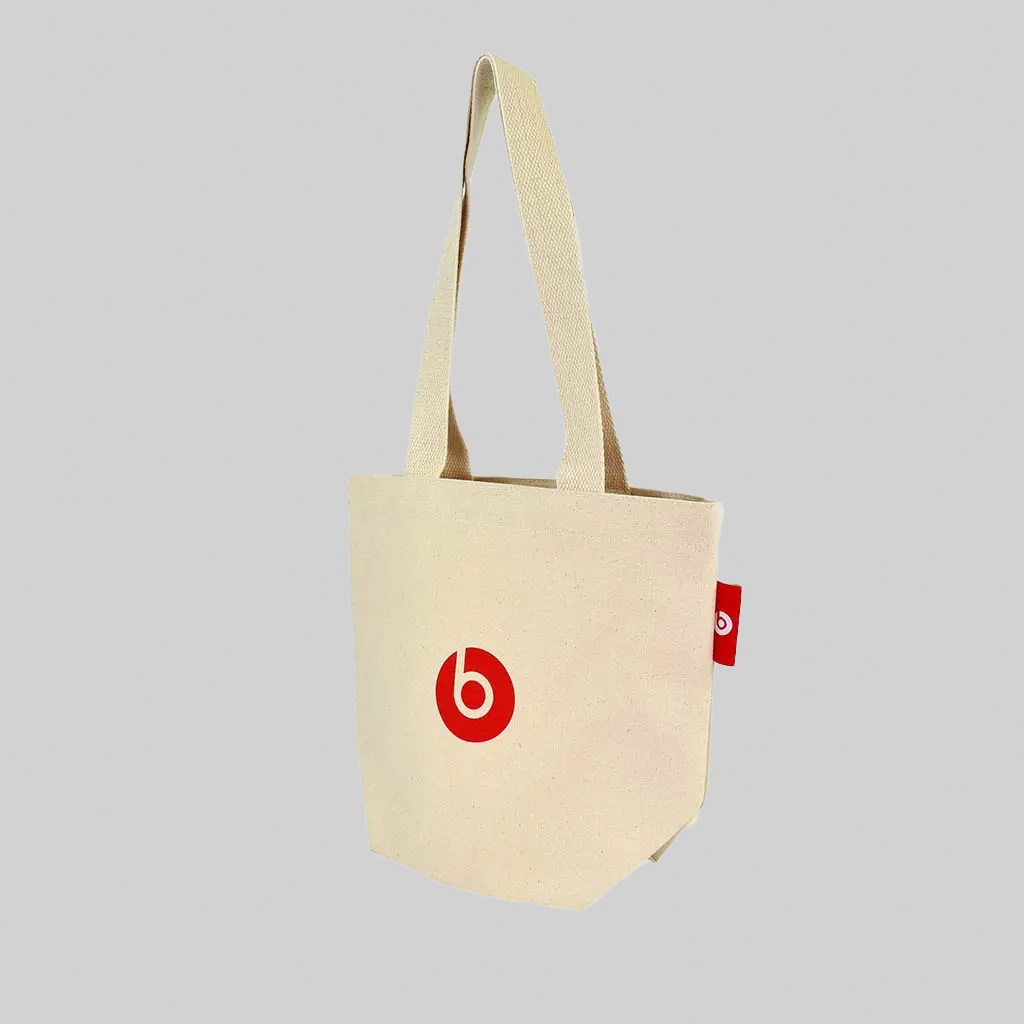 natural tote bag with Beats by Dre red logo on the bag and red woven label how to work with a British vendor