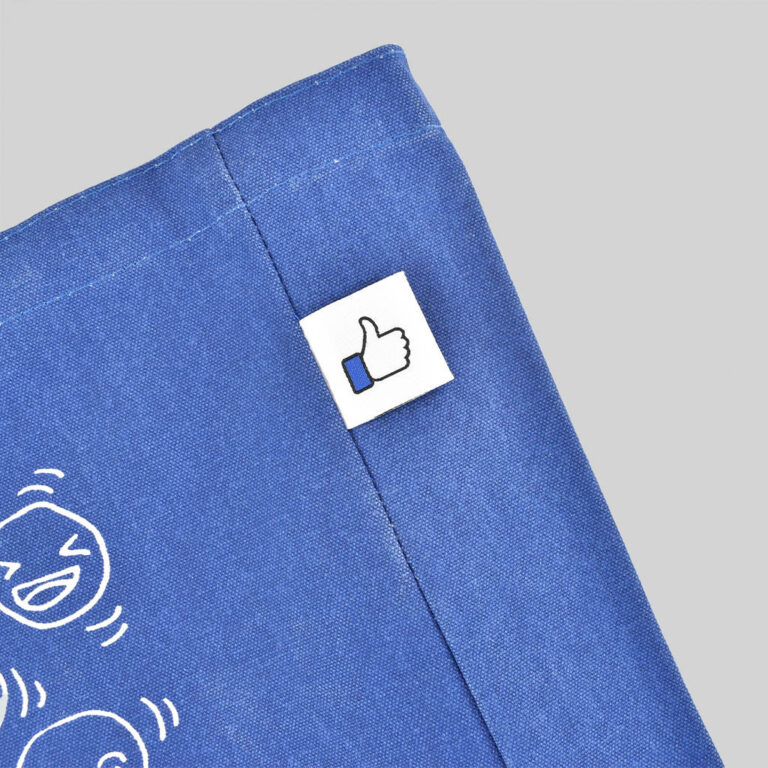 blue carryall with white woven label for how to work with a British vendor