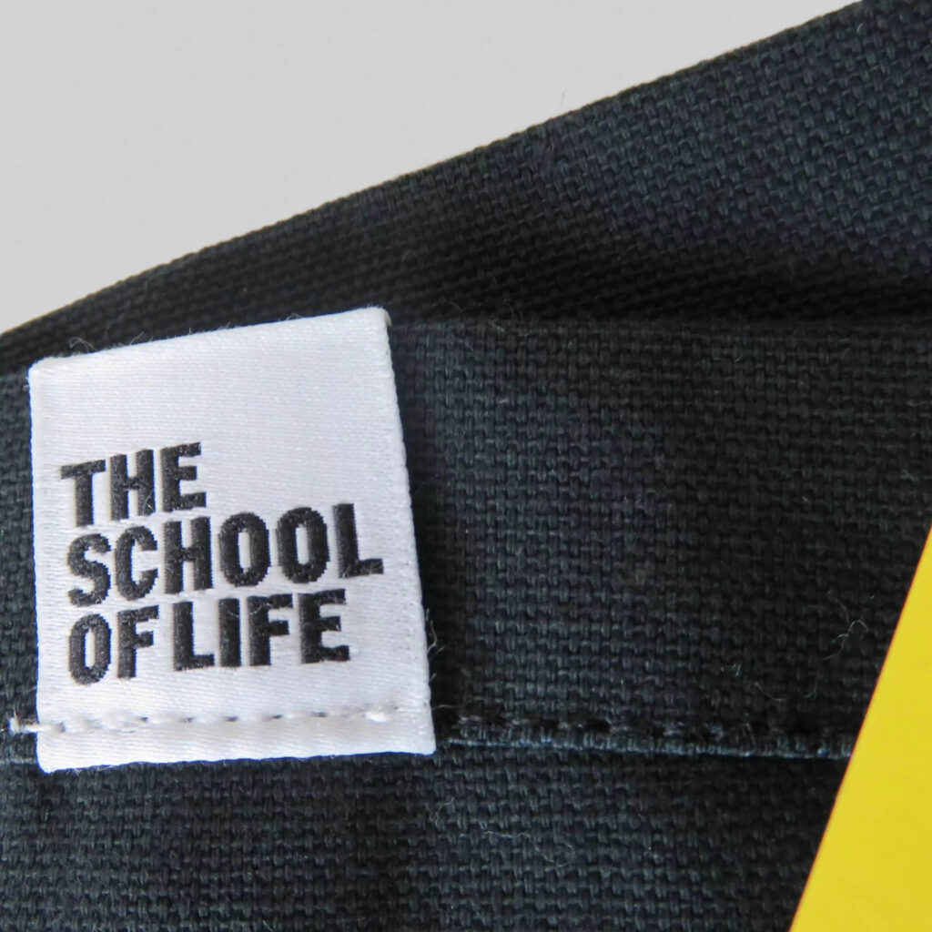 woven label with School of Life logo on grey canvas tote bag