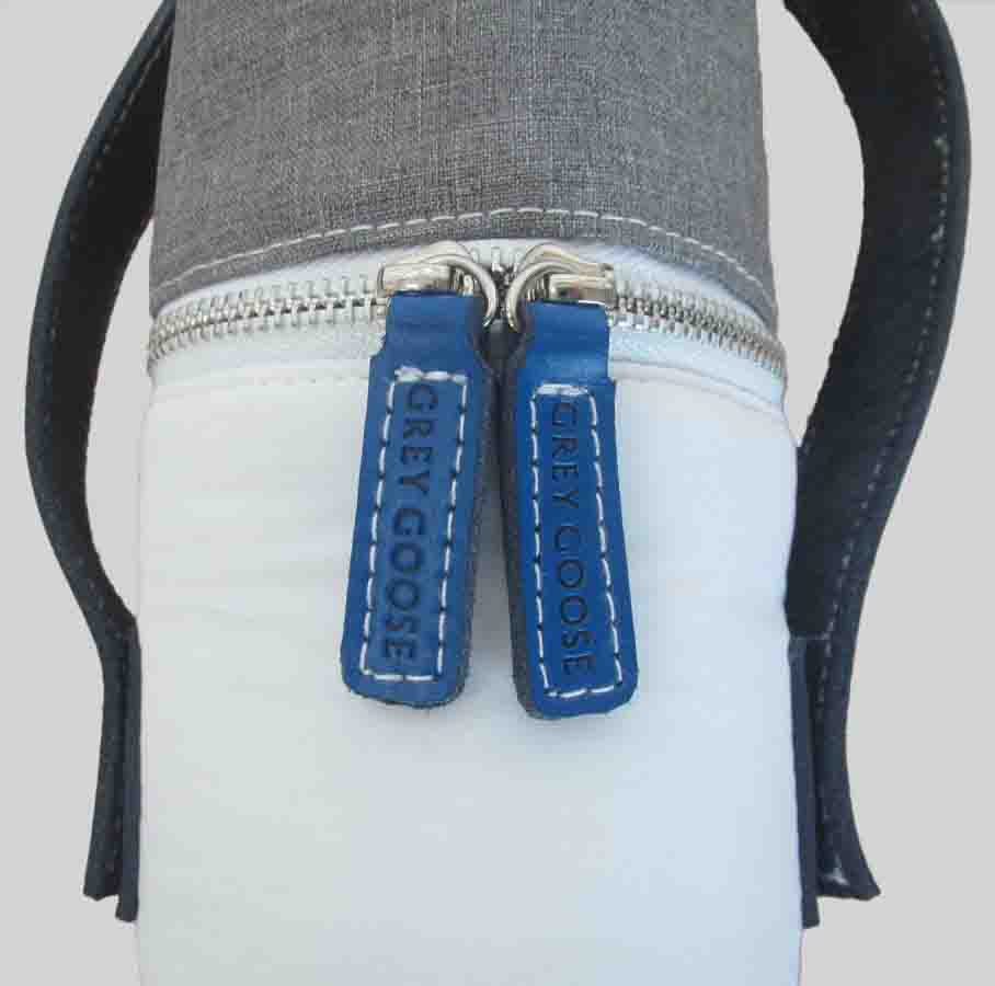 Grey Goose embossed blue zip pulls on white bottle bag with grey lid and black leather straps